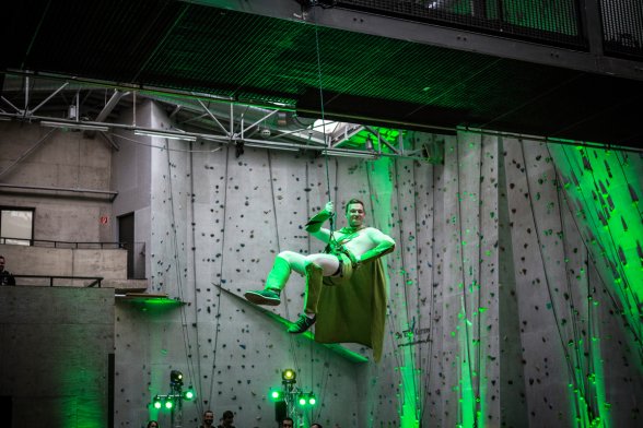 Spektakuläre Inszenierung: Ein Superman in Grün-Weiß wird von der Decke herabgelassen