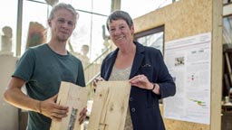 Projektleiter Christian Brosig präsentiert Bundesbauministerin Dr. Barbara Hendricks Steckverbindungen, mit denen die Wandmodule verbunden werden (Bild: Thilo Schmülgen / TH Köln)