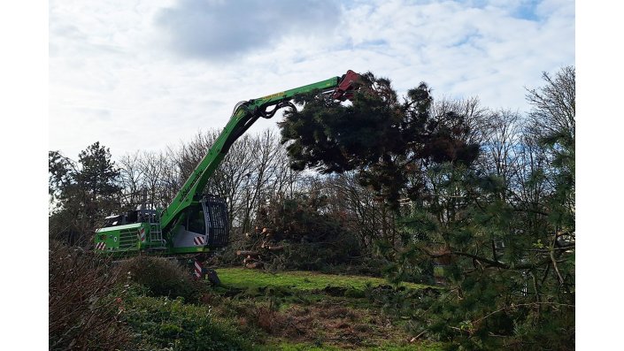 Ein grüner Bagger aufd er Baustelle.