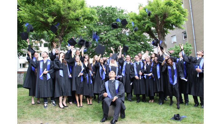 Ein Gruppenfoto der Bachelorabsolventen des Wintersemesters 2014/2015 beim Hochwerfen der Hüte