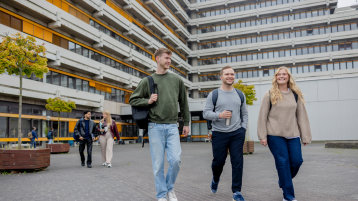 Mehrere Studierende gehen vor dem Gebäude am Campus Deutz entlang (Bild: Hanna Witte/TH Köln)