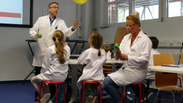 Prof. Dr. Richard Hirsch und Johanna Zajac zeigen anhand von Luftballons den Treibhauseffekt (Bild: Konstancja Laura Schmidt/TH Köln)