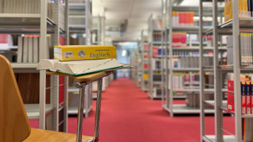 Blick in Lesesaal mit englischem Buch im Fokus (Image: TH Köln/ Alina Beier)