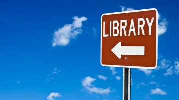 Library sign against blue sky (Image: iStock / jganser)