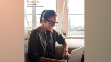 Eine Person lehnt an einer Couch, arbeitet am Laptop und trägt Kopfhörer (Bild: Elsevier) Eine Person lehnt an einer Couch, arbeitet am Laptop und trägt Kopfhörer (Bild: Elsevier)