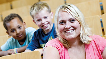 Junge Frau mit zwei kleinen Kindern im Hörsaal (Bild: Boris Loehrer / TH Köln)