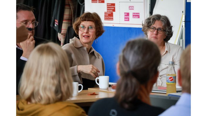 Mitglieder des EZ diskutieren an einem Tisch..