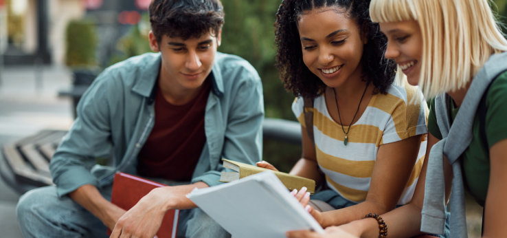 Group of happy students learning for upcoming exams together at campus.  (Image: Adobe Stock / Drazen)