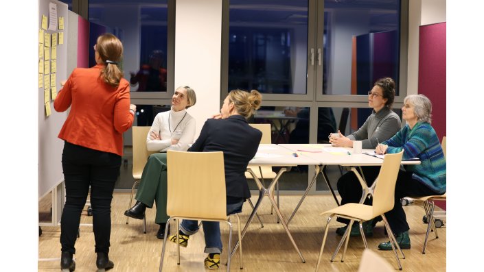 Tischhost Ilona Arcaro präsentiert die an eine Pinnwand gehefteten bisherigen Impulse.